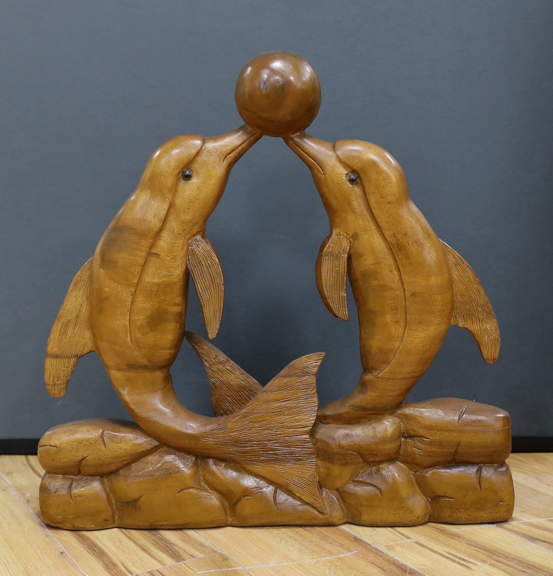 A carved dolphin group from Dolphin Square Baths, London, 59cm